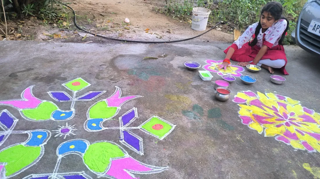 A colourful Sankranti muggu (rangoli) drawn at the threshold during the Telugu harvest festival