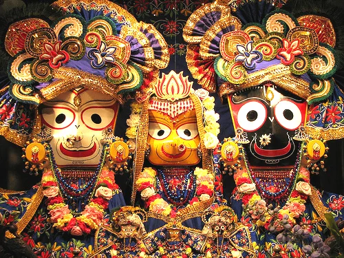Lord Jagannath with Balabhadra and Subhadra in ceremonial dress and garlands, the devotion Odia families share across the whole of Odisha