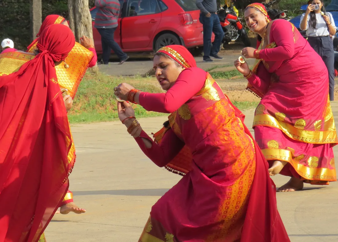 Kodava women in traditional sarees performing the Ummattat, the graceful cymbal dance of the Kodava community, during a Puthari celebration